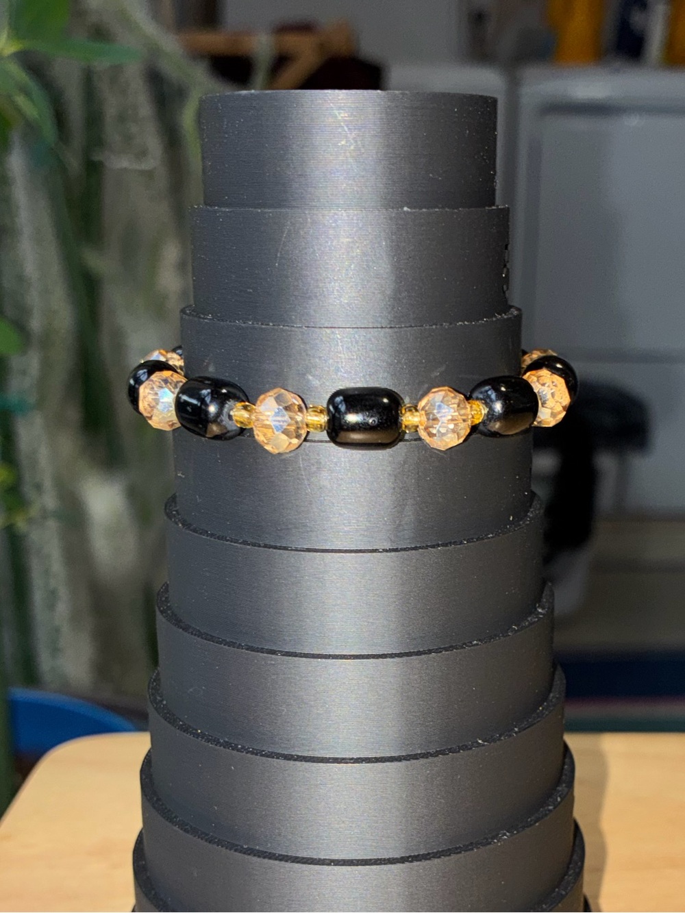 Black and Gold Beaded Stretch Bracelet with Iridescent Flower Charm - Picture 6 of 9